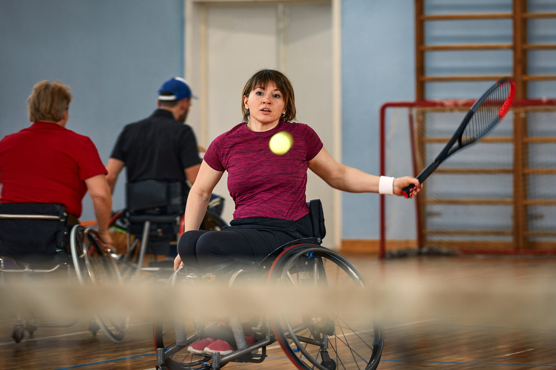People in wheelchair playing tennis on court. Wheel Chair Tennis For handicapped