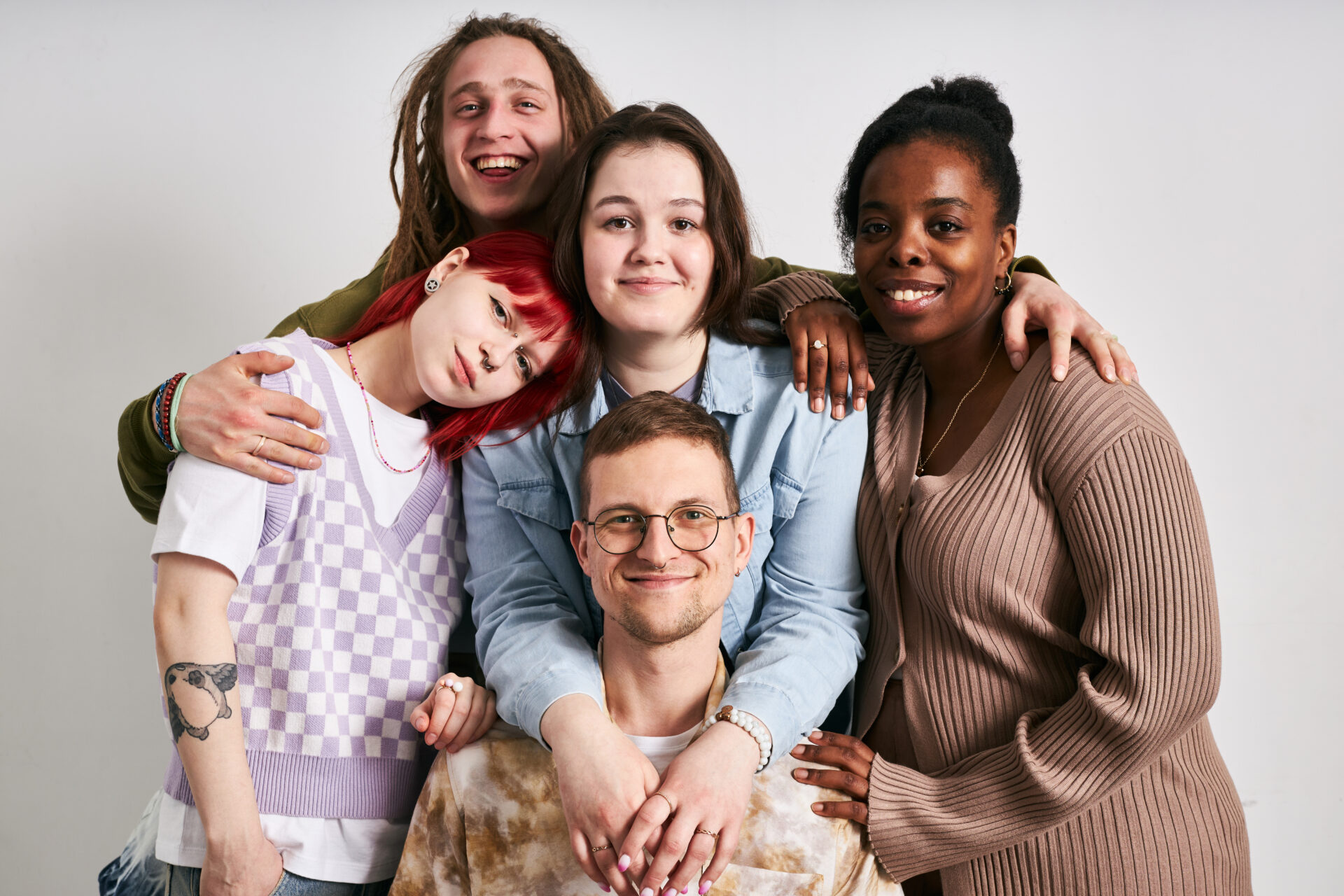 Portrait of a diverse group of friends smiling and posing together for a photo, demonstrating their close bond and joyful camaraderie