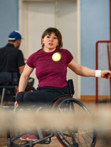 People in wheelchair playing tennis on court. Wheel Chair Tennis For handicapped