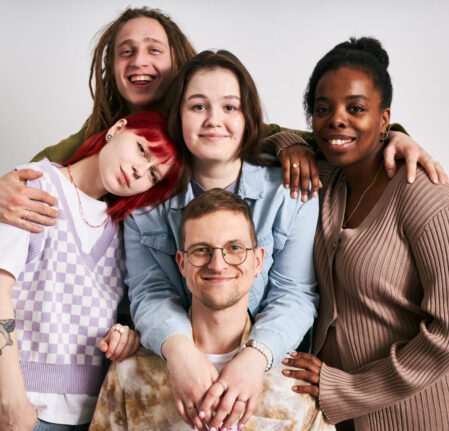 Portrait of a diverse group of friends smiling and posing together for a photo, demonstrating their close bond and joyful camaraderie